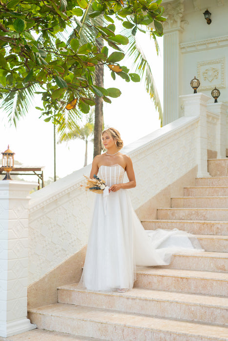 Modern bridal gown with corset and long train.