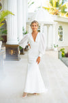 Features a deep plunging neckline that delicately connects with raised waistline seam, complemented with sheer chiffon long sleeves, mermaid cut with modern open back, long train wedding dress.