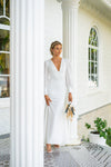 Features a deep plunging neckline that delicately connects with raised waistline seam, complemented with sheer chiffon long sleeves, mermaid cut with modern open back, long train wedding dress.